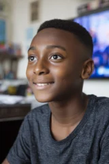A happy autistic teenage boy at home.