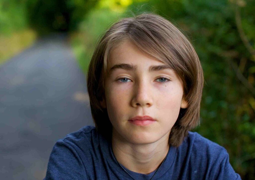 serious teenage boy outdoors