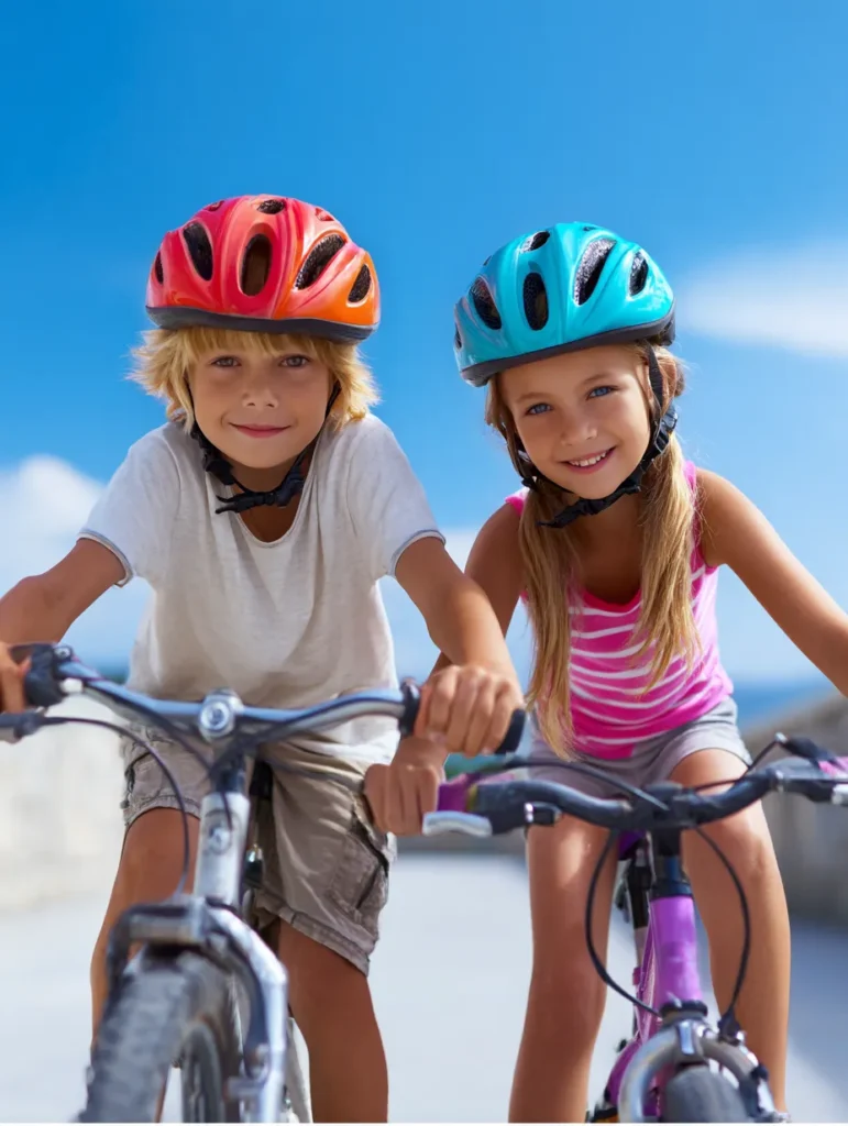 two happy children riding their bikes