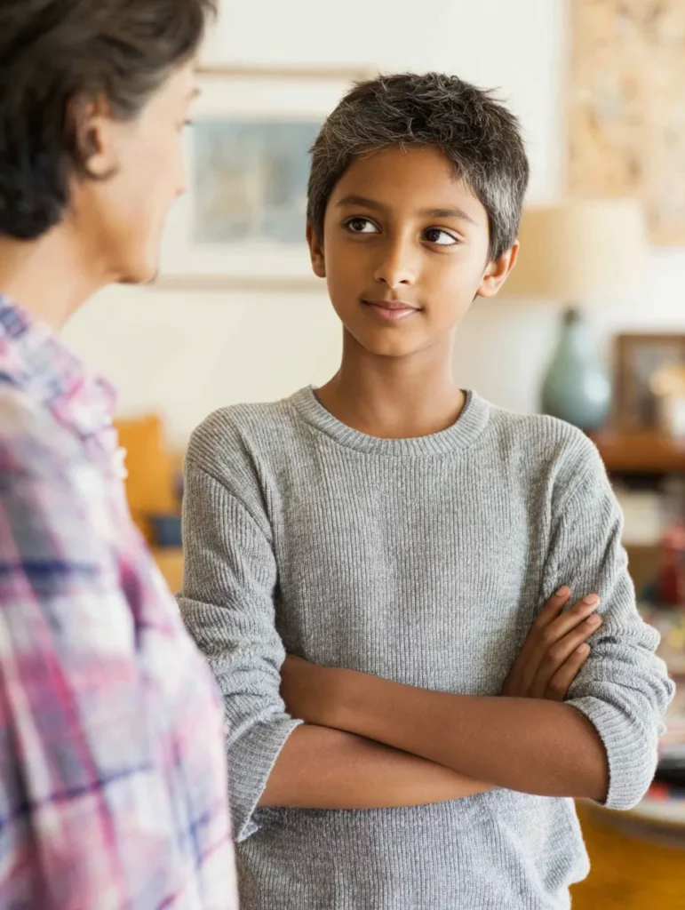 a thirteen year old boy at home chatting with his mother