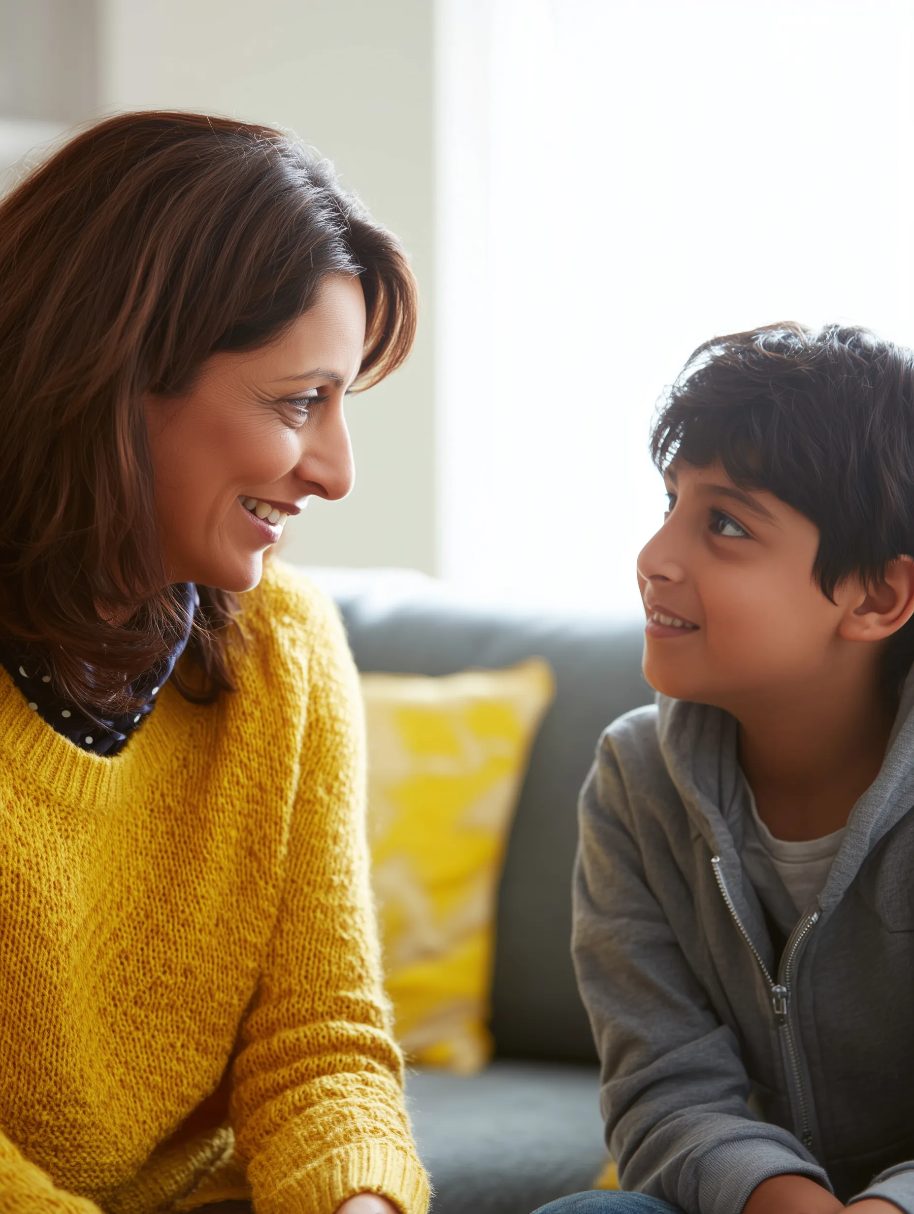 a mum and son chatting on their sofa