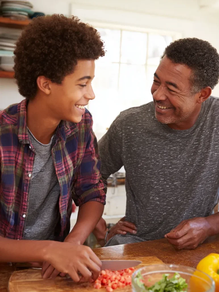 a dad ad teen son cooking together