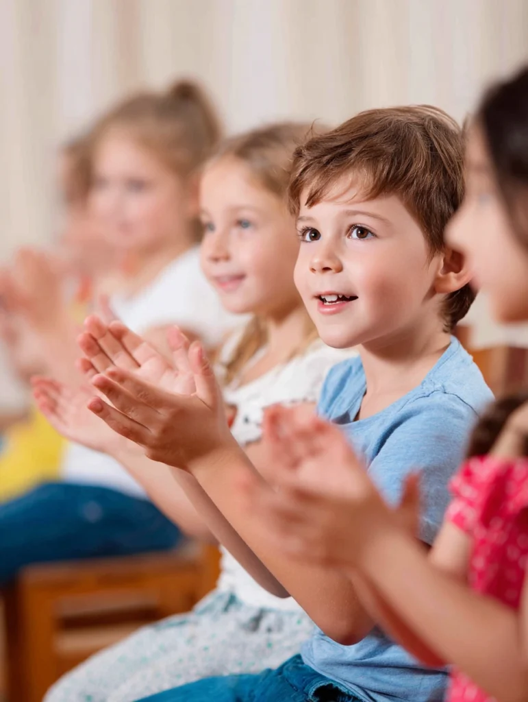 happy 5 year old children clapping together