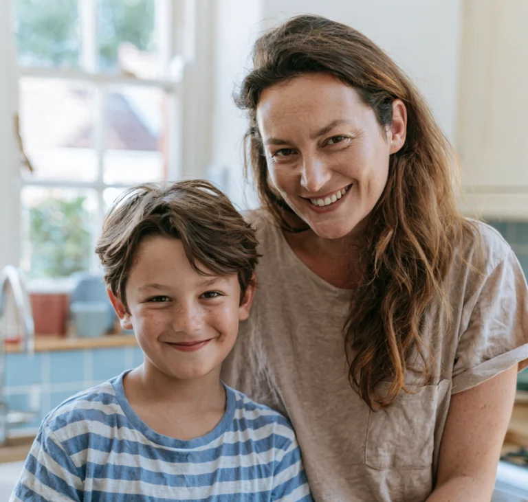 A mother and son, together in their kitchen, with a baking bowl next to them