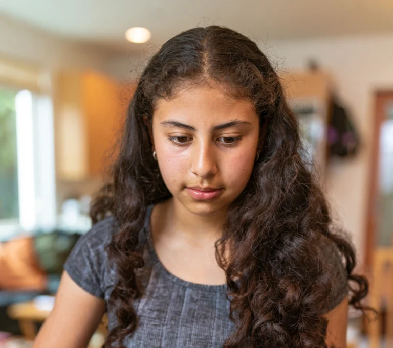 A teenage girl packing a small bag, ready to move between her two homes